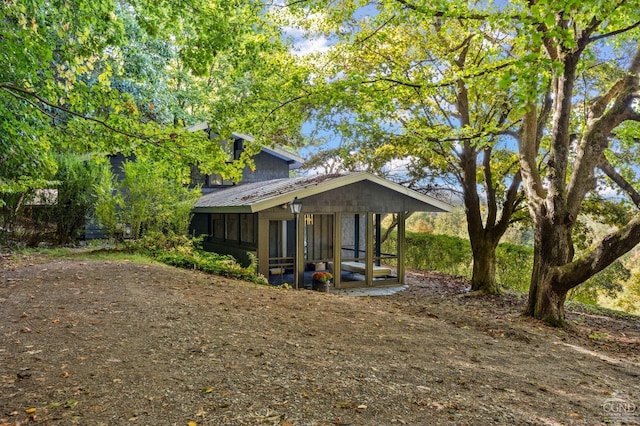 view of home's exterior with a sunroom