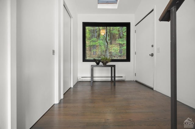 corridor with baseboard heating and dark wood-type flooring