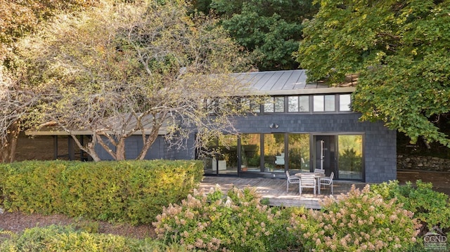 back of property with a wooden deck