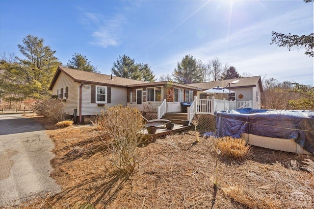 ranch-style house with a wooden deck