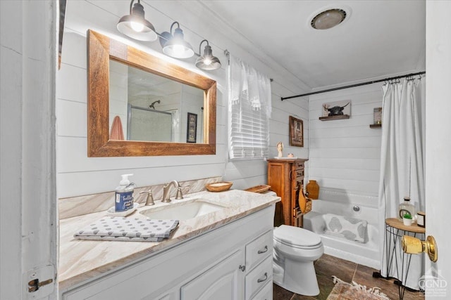 bathroom with vanity, a shower stall, toilet, and ornamental molding