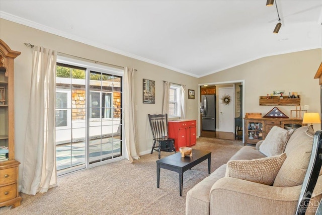 living area with light carpet, baseboards, lofted ceiling, and ornamental molding