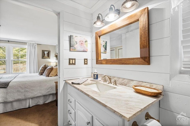 bathroom with vanity, ornamental molding, and ensuite bathroom