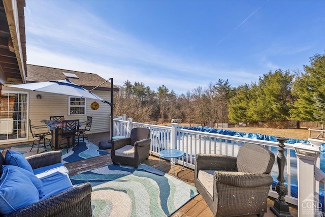 wooden deck featuring outdoor dining space