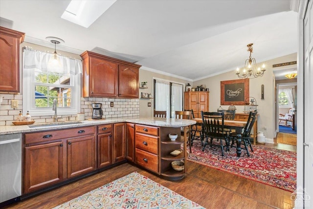 kitchen featuring a sink, lofted ceiling with skylight, dishwasher, a peninsula, and dark wood-style flooring