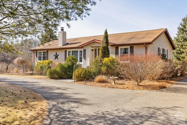 ranch-style house featuring a chimney