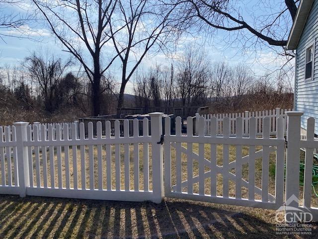 view of gate with fence