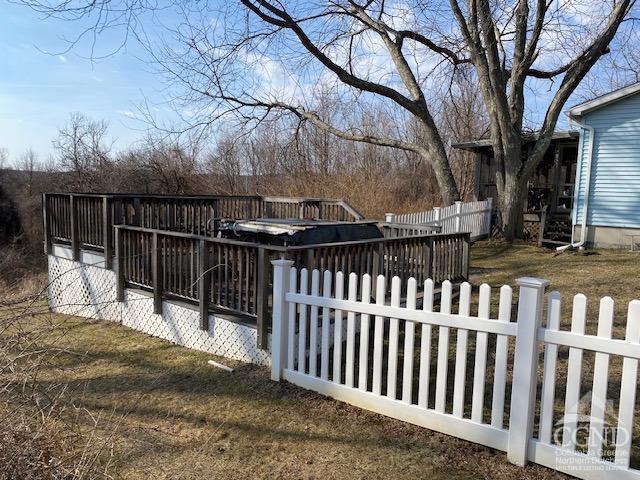 exterior space featuring fence and a wooden deck