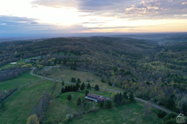 aerial view at dusk of a view of trees and a view of rural / pastoral area