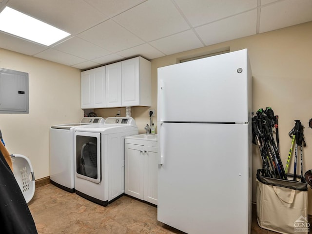 laundry room with cabinets, washing machine and dryer, and electric panel