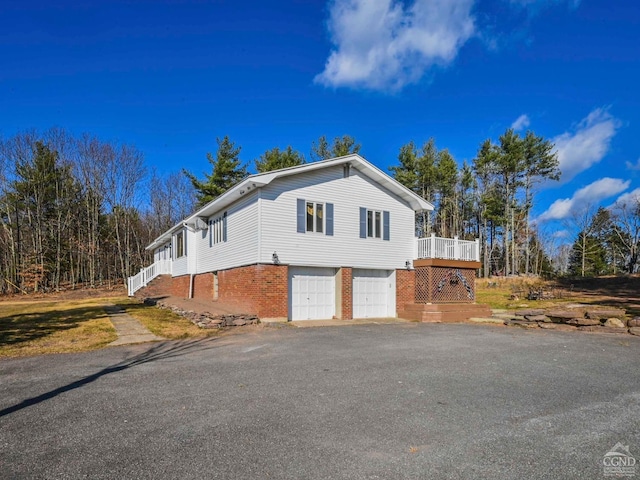 view of home's exterior featuring a garage and a wooden deck