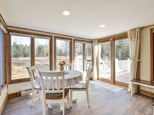 sunroom featuring a baseboard heating unit