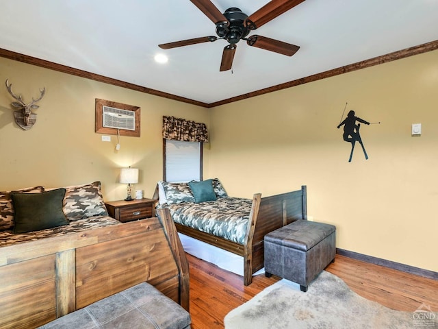 bedroom featuring wood-type flooring, an AC wall unit, ceiling fan, and ornamental molding