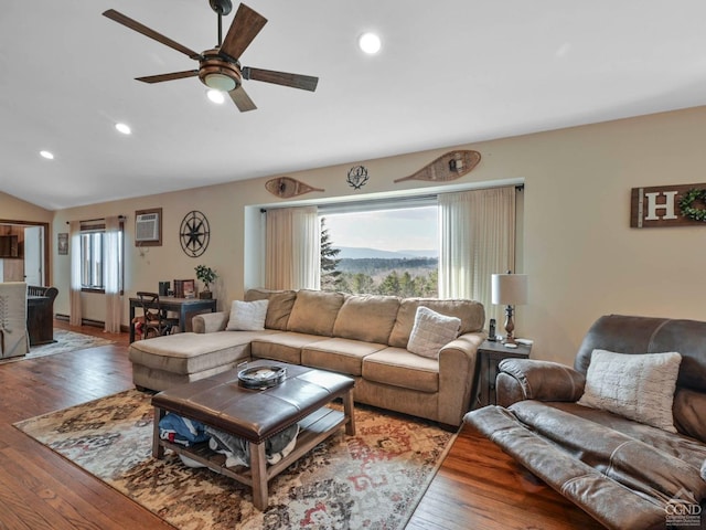 living room with hardwood / wood-style floors, ceiling fan, and lofted ceiling