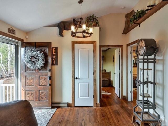 entrance foyer featuring a chandelier, dark hardwood / wood-style flooring, and vaulted ceiling