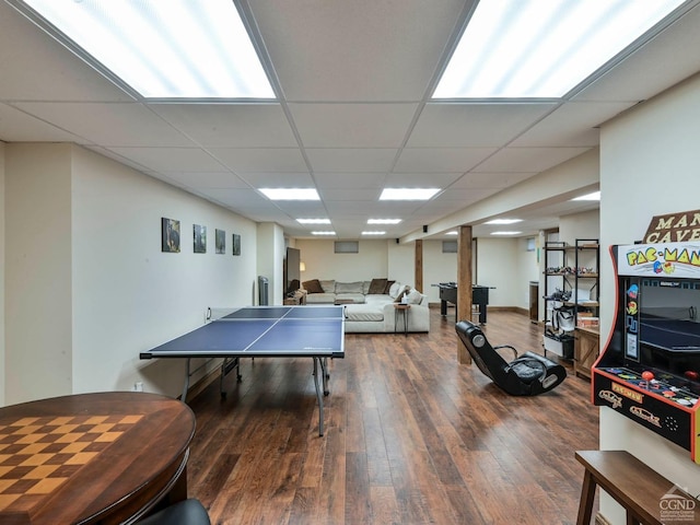 game room with dark hardwood / wood-style flooring and a drop ceiling