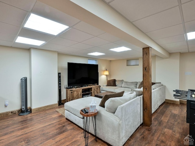 living room with a paneled ceiling and dark hardwood / wood-style flooring