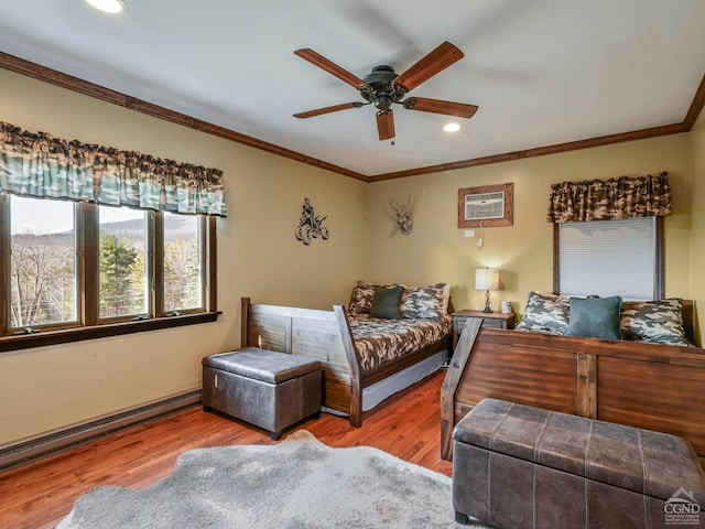 bedroom featuring light hardwood / wood-style flooring, ceiling fan, ornamental molding, baseboard heating, and a wall unit AC