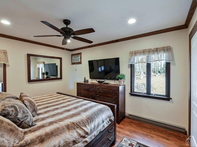 bedroom featuring light hardwood / wood-style flooring, ceiling fan, a baseboard heating unit, and crown molding