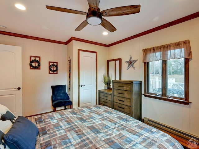 bedroom with crown molding, ceiling fan, and a baseboard heating unit