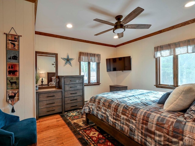 bedroom featuring ceiling fan, light wood-type flooring, and crown molding