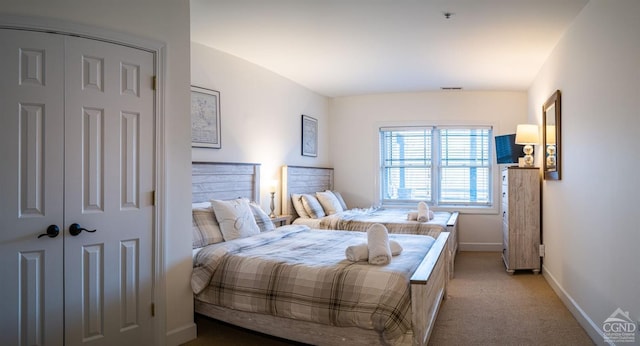 bedroom featuring light carpet, vaulted ceiling, and a closet