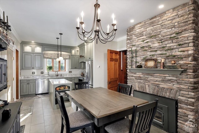 tiled dining area with an inviting chandelier, crown molding, and sink