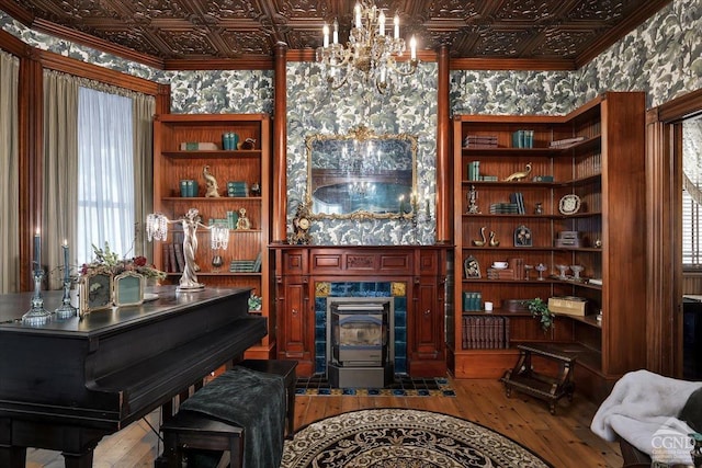 interior space with wood-type flooring, an inviting chandelier, and ornamental molding