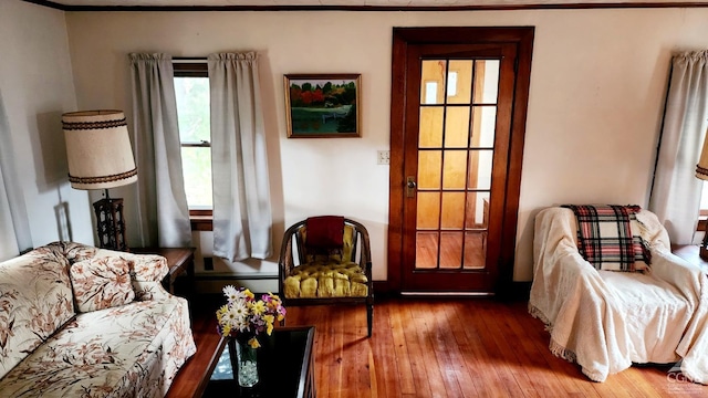 sitting room featuring crown molding and hardwood / wood-style flooring