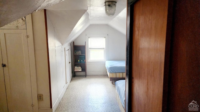 corridor featuring vaulted ceiling