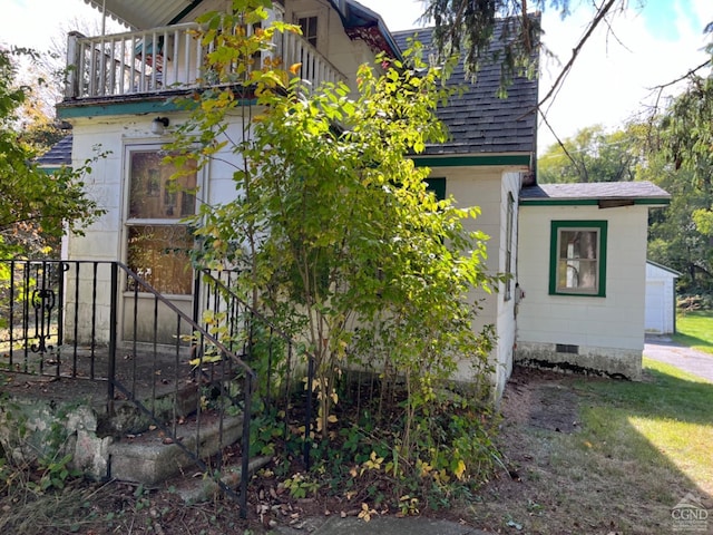 view of side of home featuring a balcony