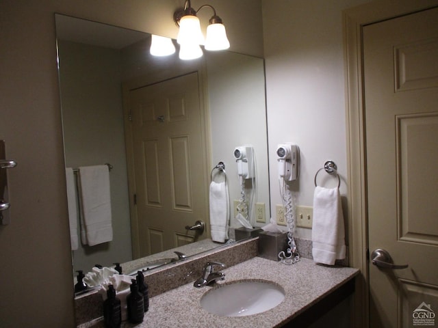 bathroom featuring vanity and a chandelier