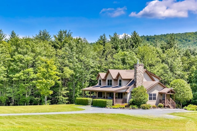 view of front of property featuring covered porch and a front yard