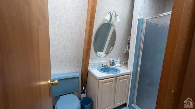 bathroom featuring vanity, a shower with shower door, and toilet