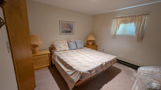 bedroom with light colored carpet and a baseboard radiator