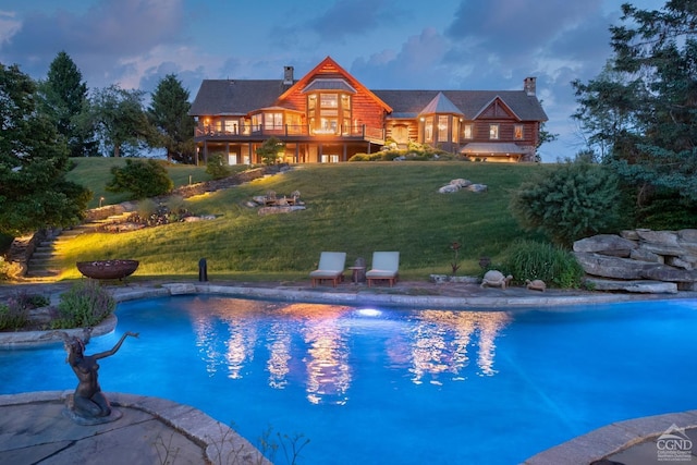 pool at dusk with a yard