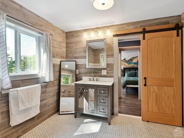 bathroom featuring vanity and tile walls