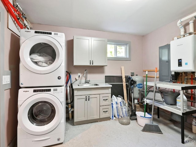 clothes washing area with cabinets, water heater, sink, electric panel, and stacked washer / drying machine