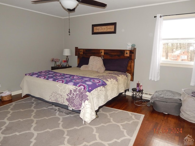 bedroom featuring a baseboard heating unit, dark hardwood / wood-style flooring, ceiling fan, and ornamental molding