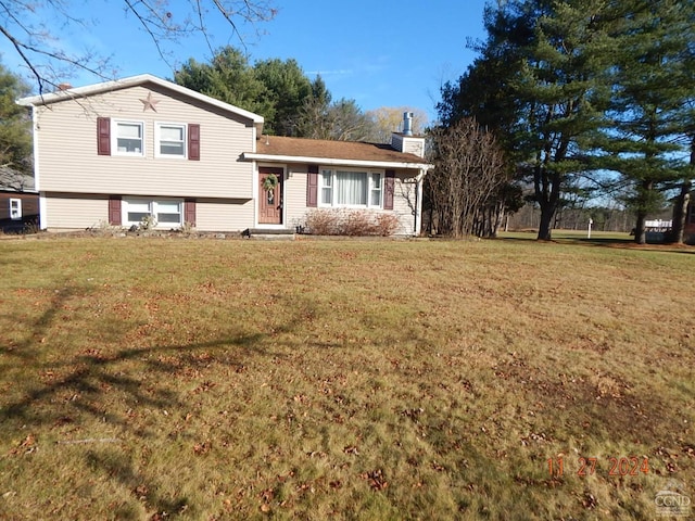 split level home with a front lawn