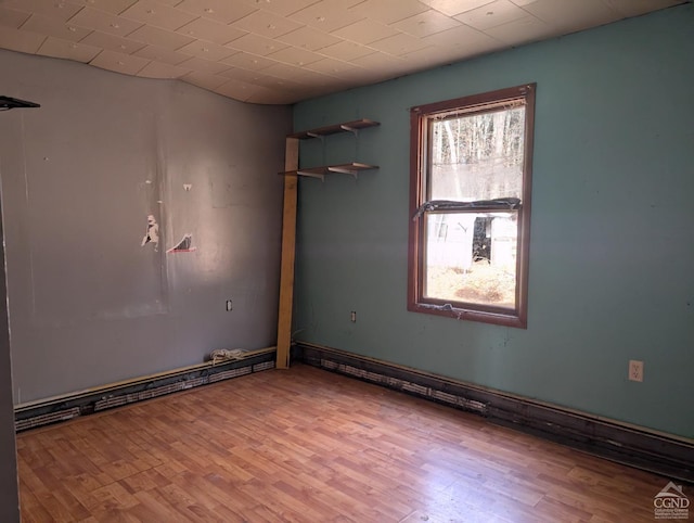 spare room with light wood-type flooring and a wealth of natural light