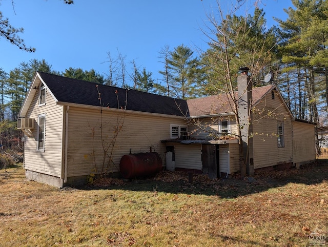 rear view of house featuring a lawn