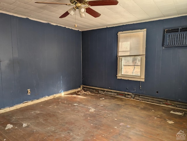 spare room featuring dark hardwood / wood-style flooring, an AC wall unit, ceiling fan, and wooden walls