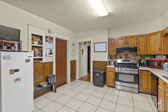 kitchen with light tile patterned floors, stainless steel appliances, and tasteful backsplash