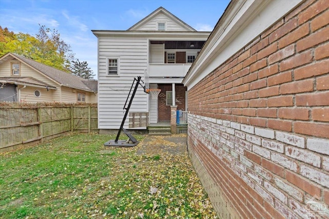 rear view of property with a yard