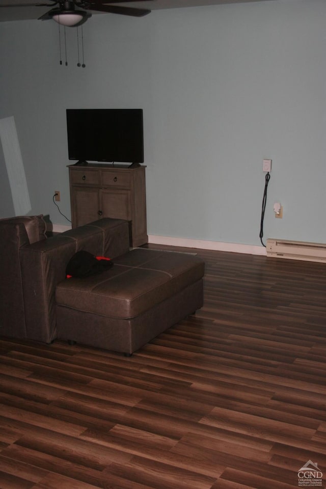 living room featuring baseboard heating and dark hardwood / wood-style floors