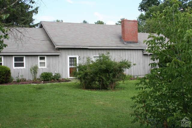 view of side of property with a yard