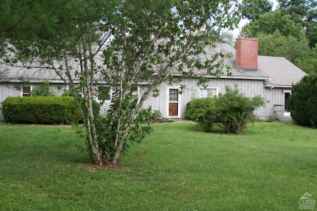 rear view of house with a lawn