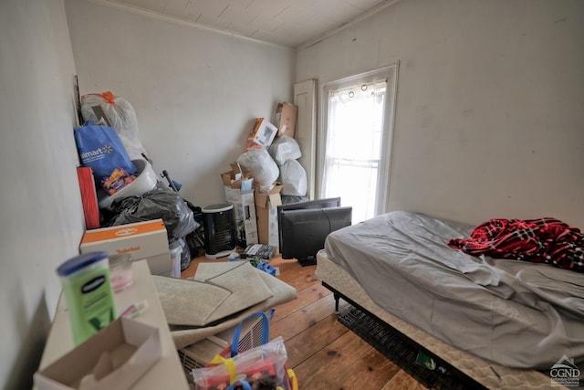 bedroom with crown molding and wood-type flooring