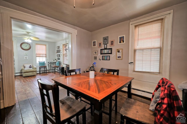 dining area with ceiling fan and a baseboard heating unit